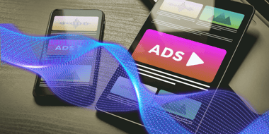Two smart phones displaying ads on their screens