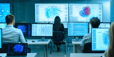 workers looking at big and small computer screens while building machine learning models